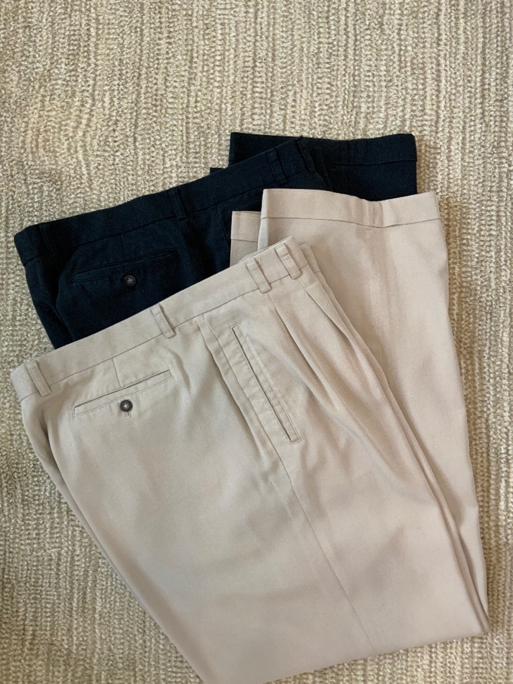 Two pairs of men’s Cutter and Buck pleated dress pants black and khaki 42x34
